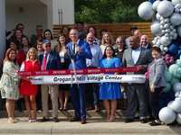 Community leaders talk with Woodlands Online at Grogan’s Mill Village Center ribbon-cutting ceremony
